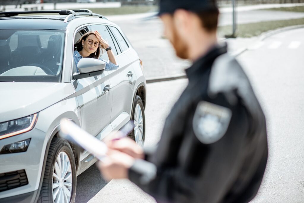 Upset female driver with policeman on the radside